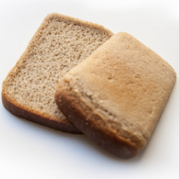 Круглый хлеб. Коричневый хлеб. Корка черного хлеба. Горбушка хлеба на белом фоне. Кусок хлеба.