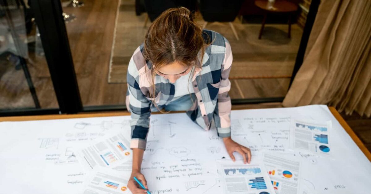 человек составляет бизнес-план за столом