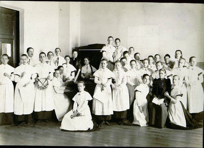 Группа институток на уроке музыки.