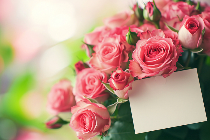 A bouquet of roses with an empty love note, close-up, soft focus background --ar 3:2 --style raw --stylize 50
