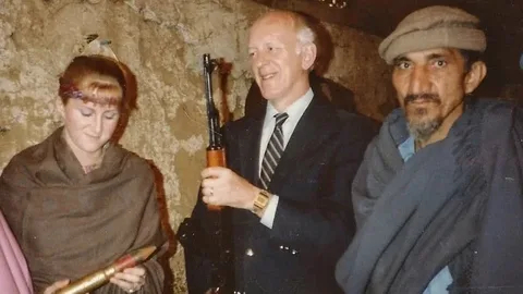 Former Canadian high commissioner Bill Warden, centre, stands with his daughter, Lisa, in an arms bazaar in Darra, Pakistan, 1982.